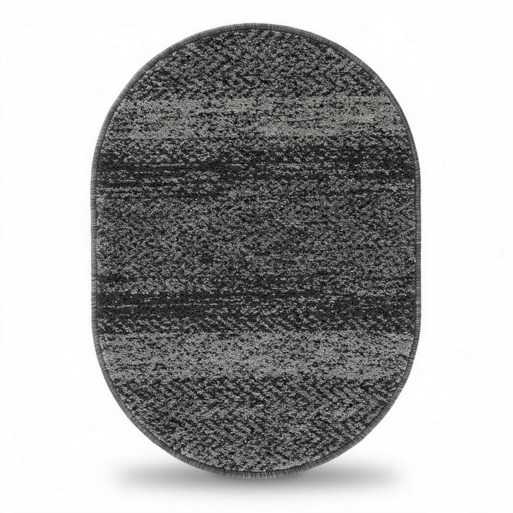 Oval area rug in grey tones crafted from durable synthetic fibers 100 x 70 x 1cm